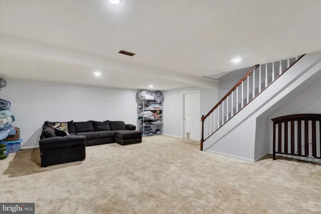 a living room with furniture and stairs