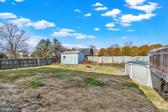 a view of a house with a patio and a yard