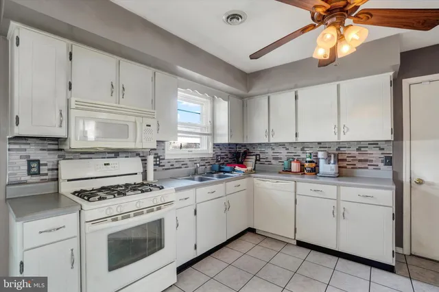 a kitchen with cabinets a sink and appliances