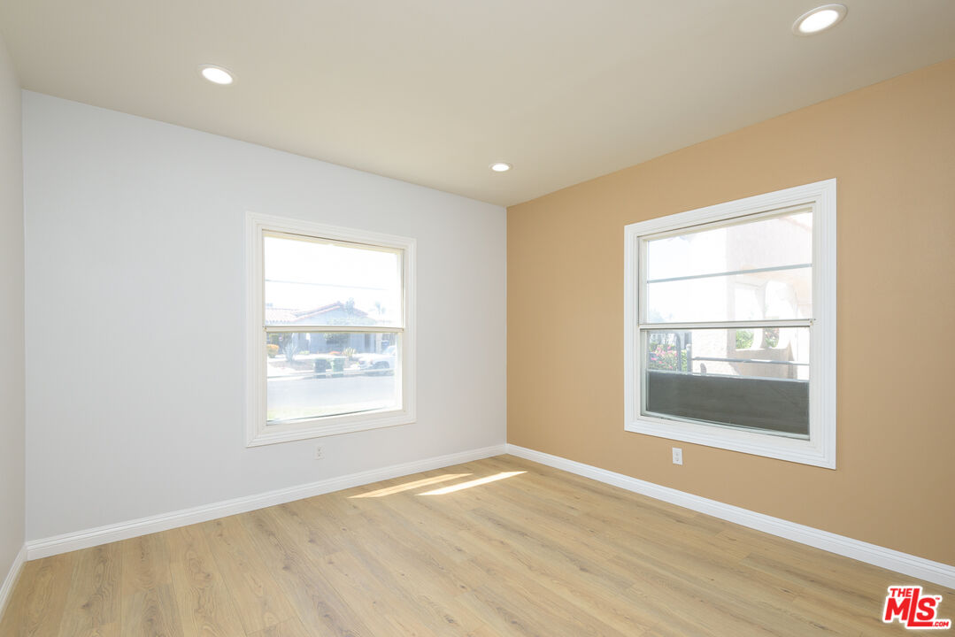 2107 West 84th Place Los Angeles, CA 90047 - Photo 15 of 25 a view of an empty room with wooden floor and a window