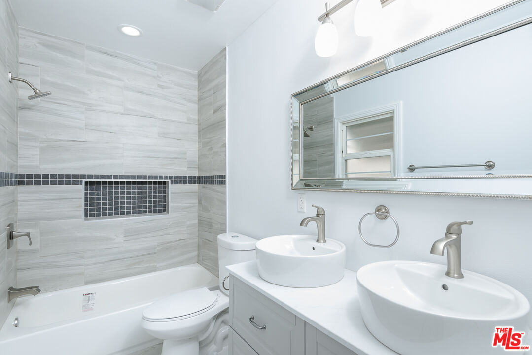 2107 West 84th Place Los Angeles, CA 90047 - Photo 17 of 25 a bathroom with a sink a toilet and shower