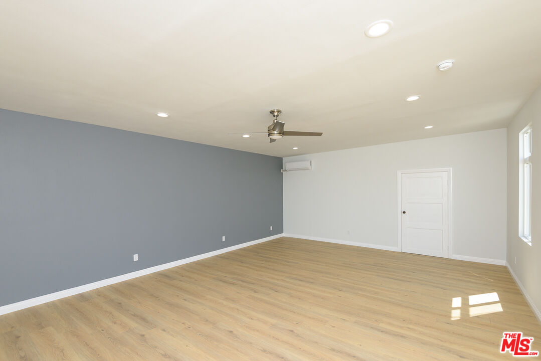 2107 West 84th Place Los Angeles, CA 90047 - Photo 20 of 25 wooden floor in an empty room with a ceiling fan