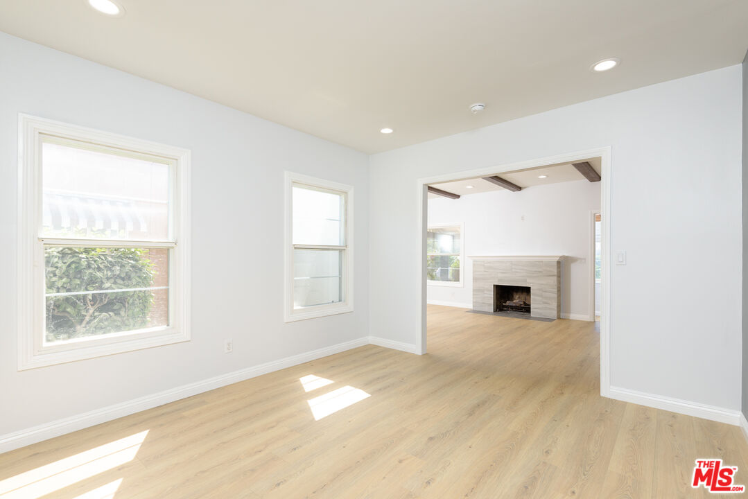2107 West 84th Place Los Angeles, CA 90047 - Photo 6 of 25 a view of empty room with wooden floor and fireplace