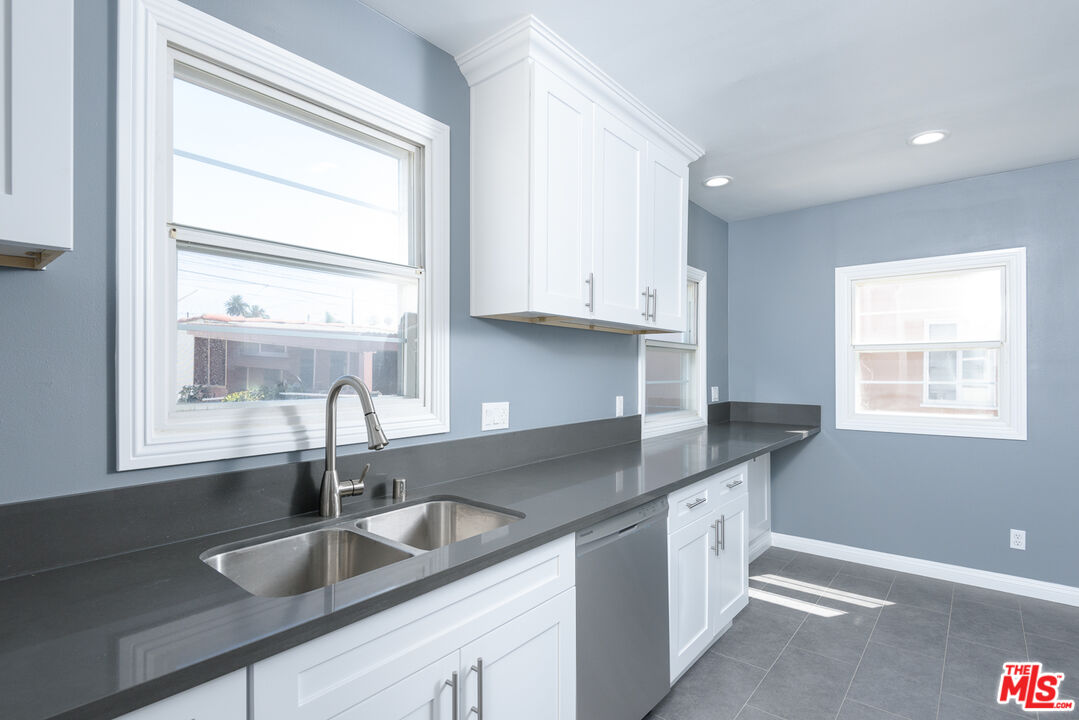 2107 West 84th Place Los Angeles, CA 90047 - Photo 10 of 25 a kitchen with granite countertop a sink and a window