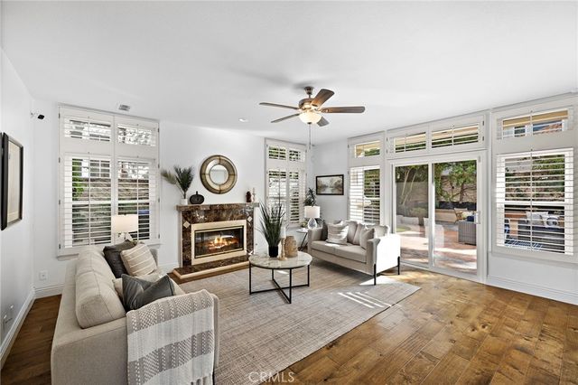 a view of a patio with couches table and chairs and potted plants