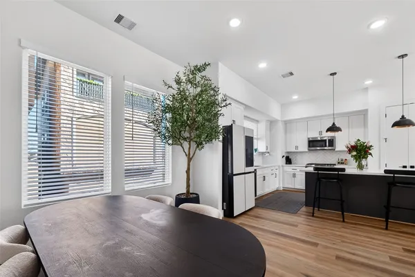 a view of a kitchen with furniture and a potted plant