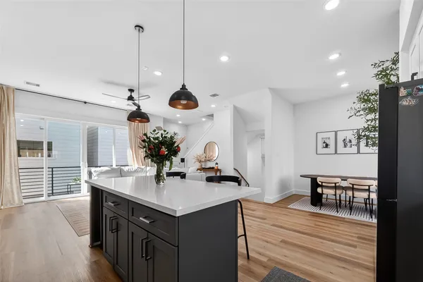 a room with stainless steel appliances kitchen island a large island in the center