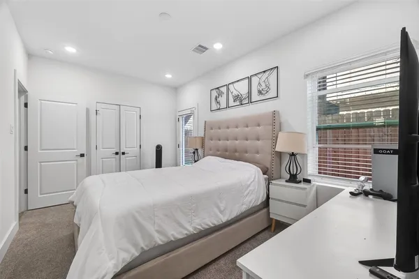 a bedroom with a bed and a large window