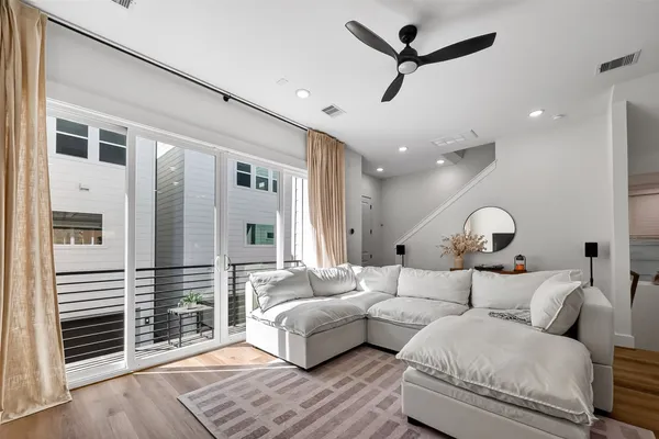 a living room with furniture and a ceiling fan
