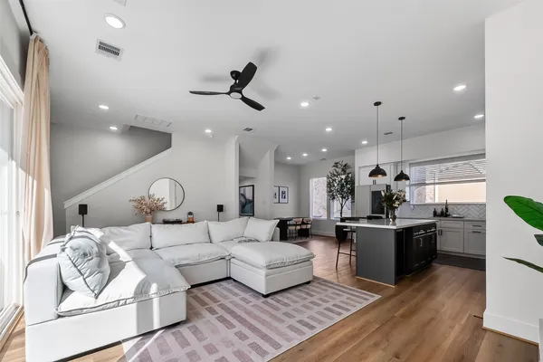 a living room with kitchen island furniture and a wooden floor