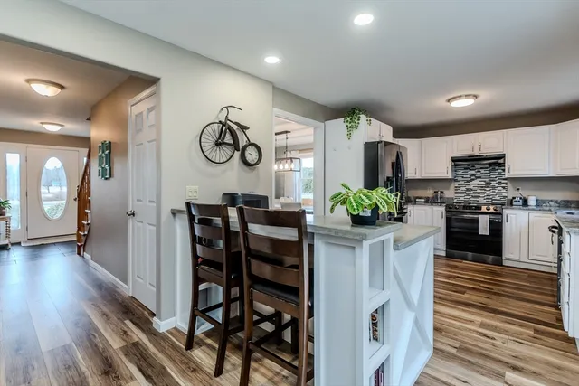 a kitchen with stainless steel appliances a stove refrigerator sink and cabinets