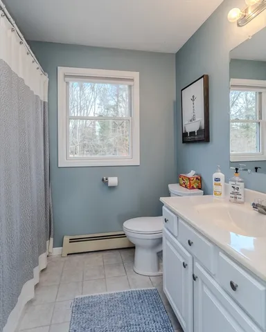 a bathroom with a sink toilet and window
