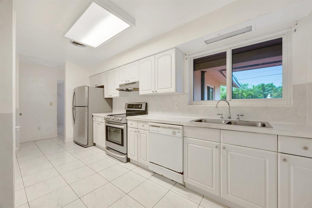 Palmetto Estates Miami, FL 33157 - Photo 33 of 48 a kitchen with stainless steel appliances a sink cabinets and a window