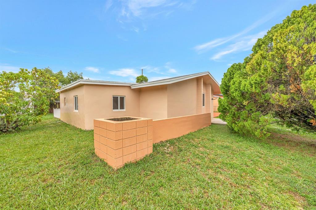 Palmetto Estates Miami, FL 33157 - Photo 45 of 48 a front view of a house with a garden