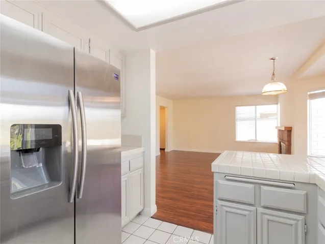 a view of empty room with wooden floor fireplace and windows