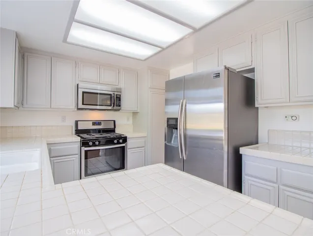 a kitchen with cabinets and stainless steel appliances