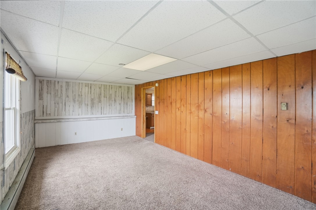 1166 West Sparrow Road Springfield, OH 45502 - Photo 26 of 40 This versatile room features warm wood paneling and natural light, perfect for any living arrangement.