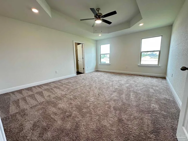a view of a livingroom with a ceiling fan and window