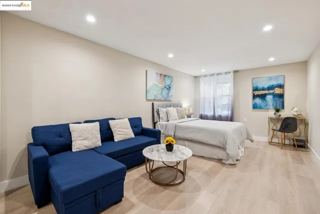 a spacious bedroom with a bed and a flat screen tv