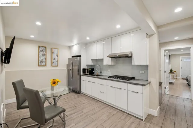 a view of a dining room with furniture wooden floor and a potted plant