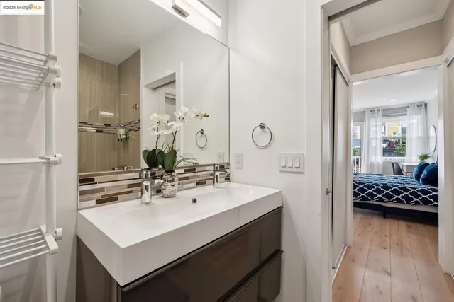 a kitchen with stainless steel appliances granite countertop a stove top oven a sink a dining table and chairs with wooden floor