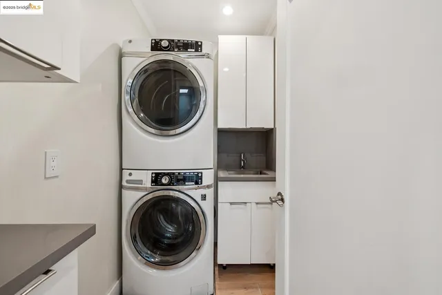 a kitchen with stainless steel appliances granite countertop a sink a stove a refrigerator and island with wooden floor