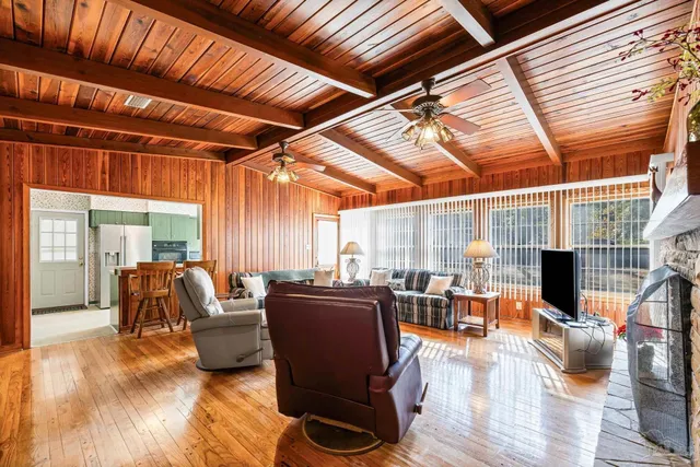 a bathroom with a double vanity sink a mirror and next to a window