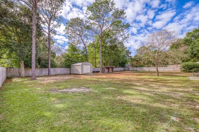 a backyard of a house with lots of green space and fountain