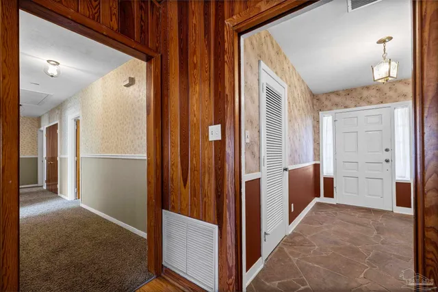 a living room with furniture and a lamp