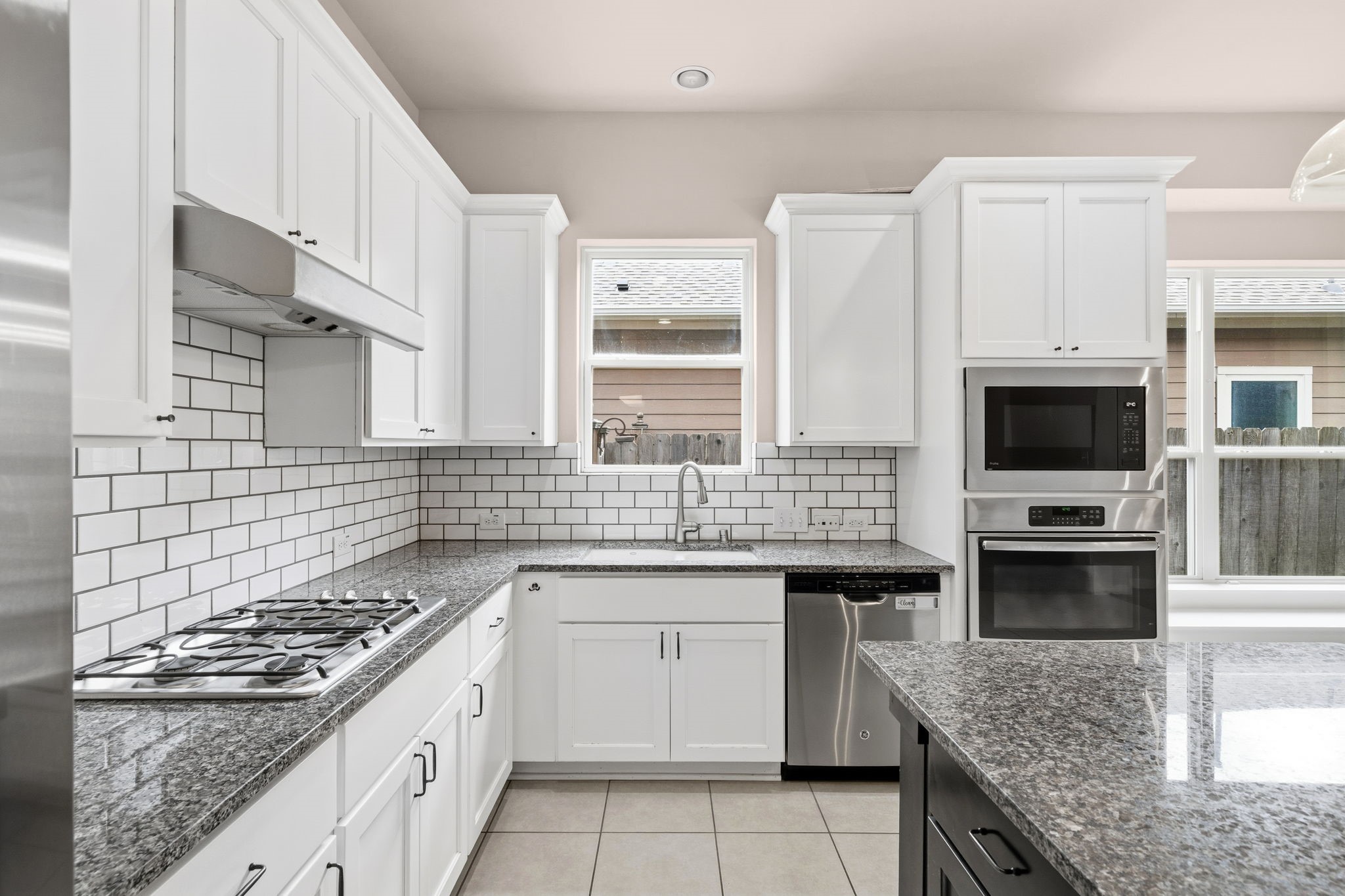 17019 Seminole Ridge Drive Cypress, TX 77433 - Photo 12 of 48 Bright and beautifully updated kitchen with crisp white cabinetry, granite countertops, and classic subway tile backsplash. Stainless steel appliances, gas cooktop, and a spacious island provide both style and functionality.