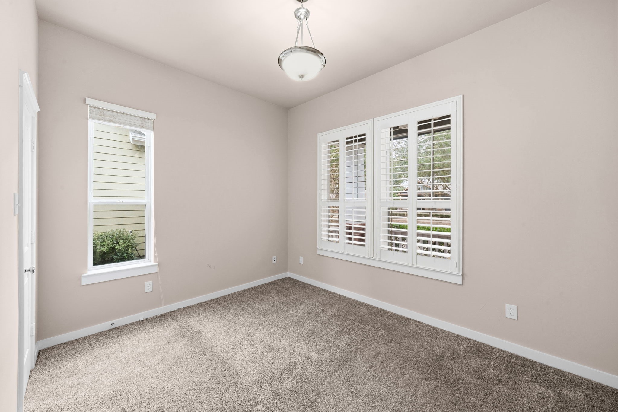 17019 Seminole Ridge Drive Cypress, TX 77433 - Photo 22 of 48 Charming secondary bedroom with plush carpet, abundant natural light, and elegant plantation shutters. Neutral tones create a comfortable and versatile space for guests or family.