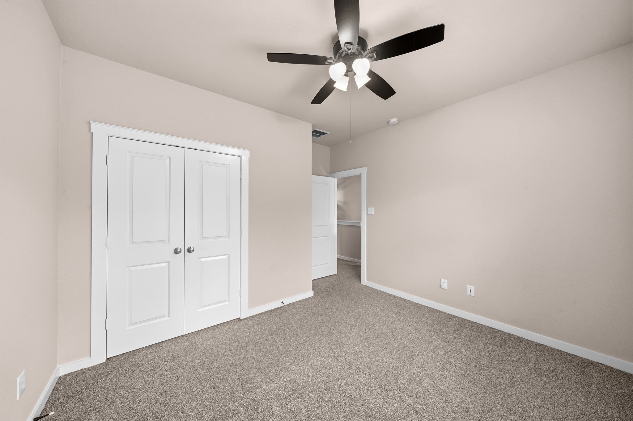 17019 Seminole Ridge Drive Cypress, TX 77433 - Photo 28 of 48 Spacious secondary bedroom with plush carpet, ceiling fan, and neutral tones. Includes a generous closet and convenient access to the upstairs living areas.