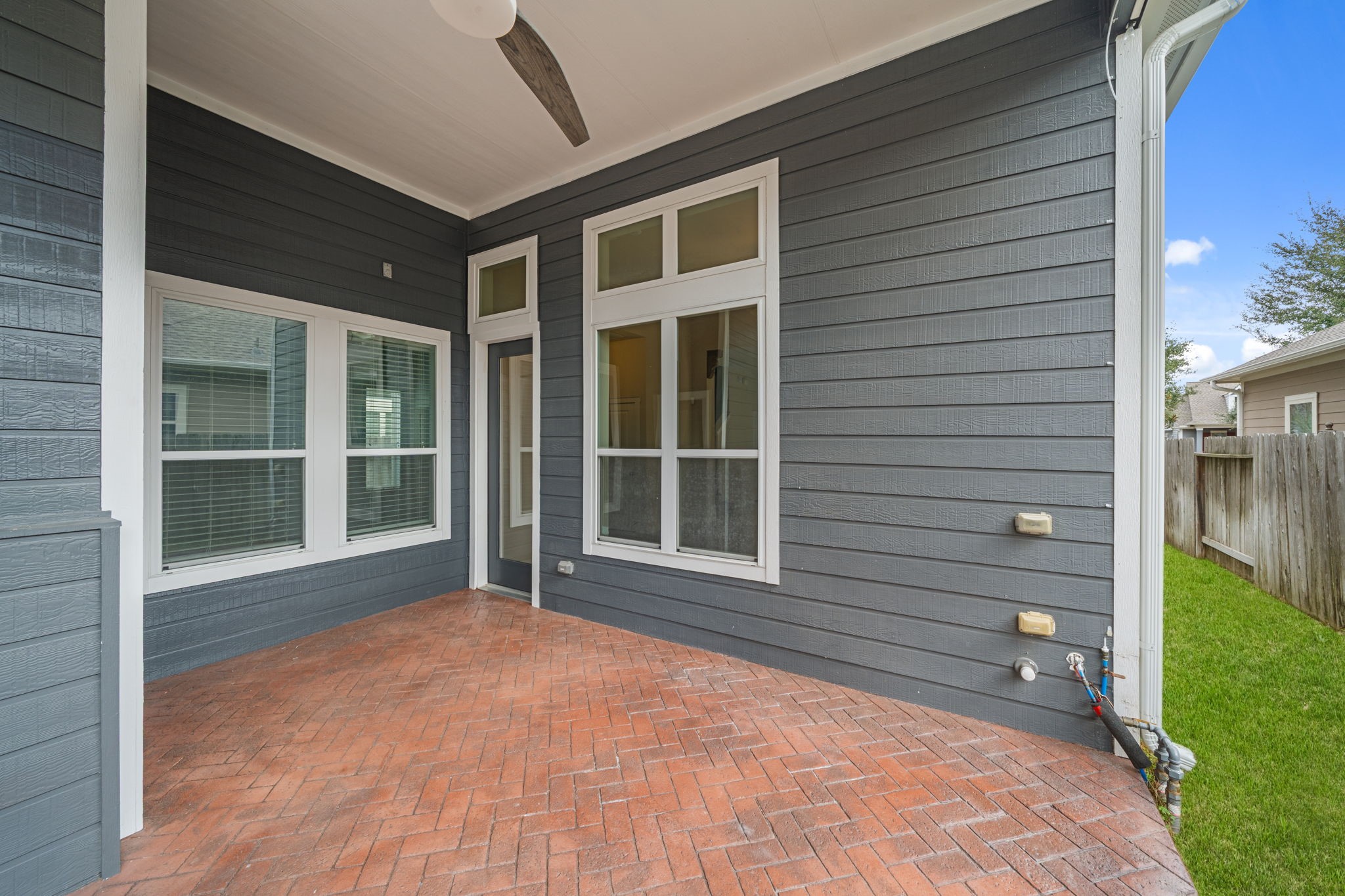 17019 Seminole Ridge Drive Cypress, TX 77433 - Photo 37 of 48 Covered back patio with classic brick flooring, elevated ceilings, large windows and rear entry provide seamless indoor-outdoor living.