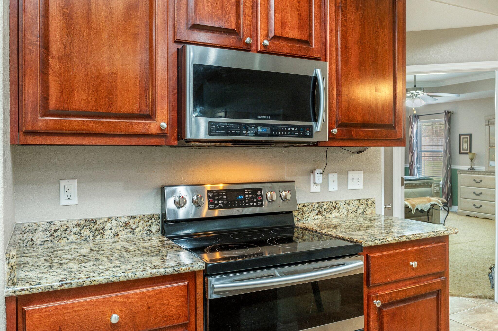 6262 Evan Circle Crestview, FL 32536 - Photo 15 of 45 a kitchen with stainless steel appliances granite countertop a stove and a microwave
