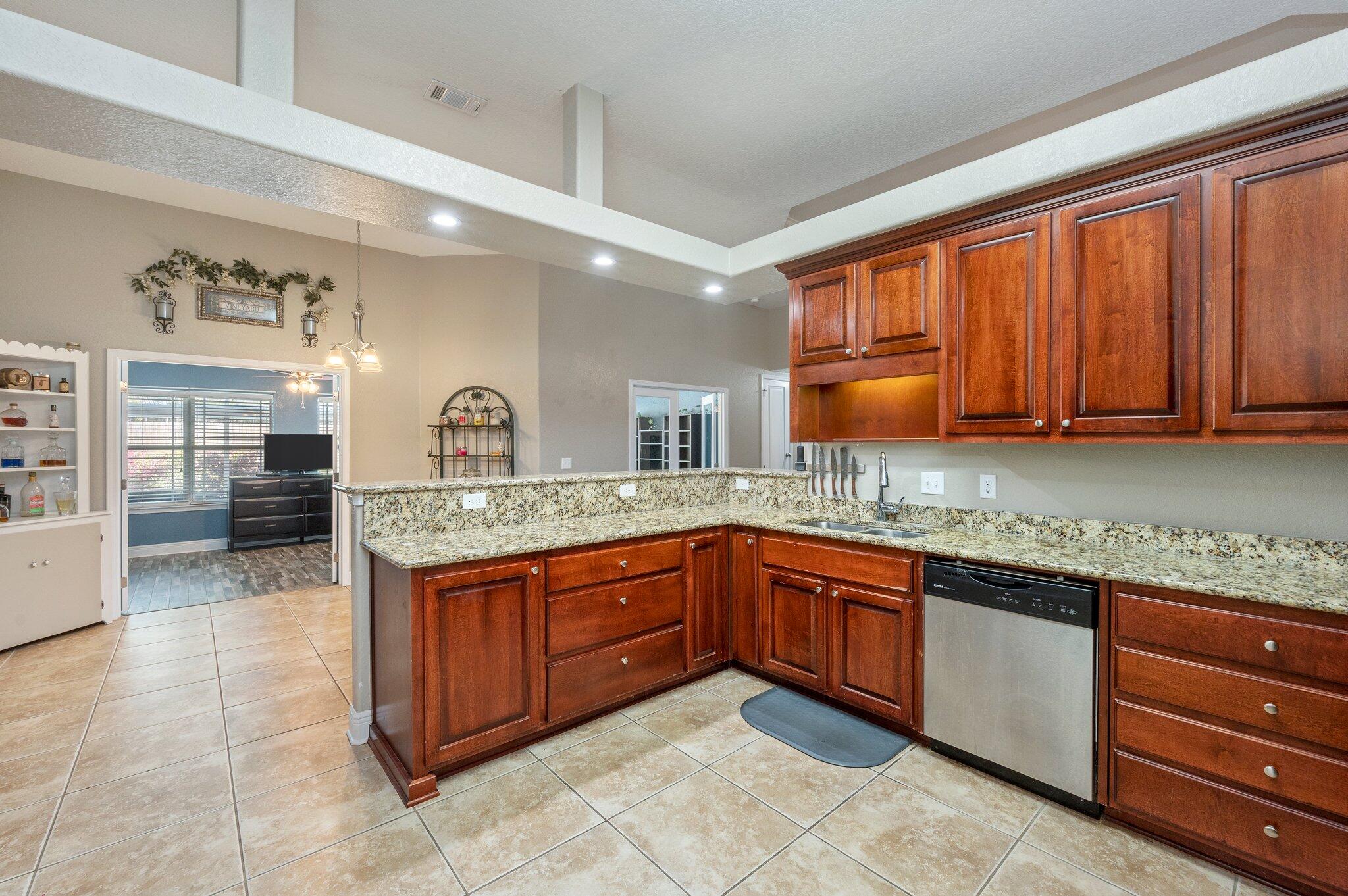 6262 Evan Circle Crestview, FL 32536 - Photo 16 of 45 a kitchen with granite countertop stainless steel appliances a sink counter space and cabinets