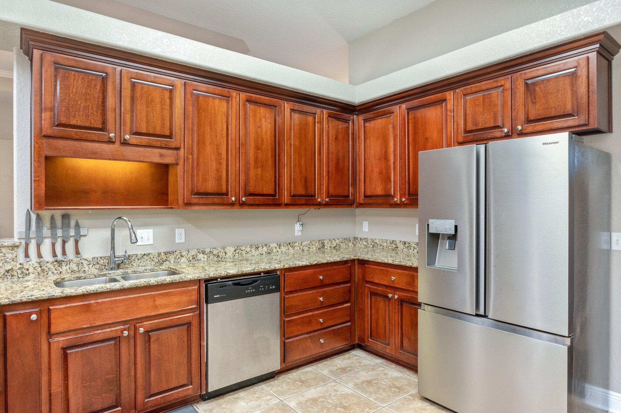 6262 Evan Circle Crestview, FL 32536 - Photo 19 of 45 a kitchen with stainless steel appliances granite countertop a refrigerator sink and cabinets