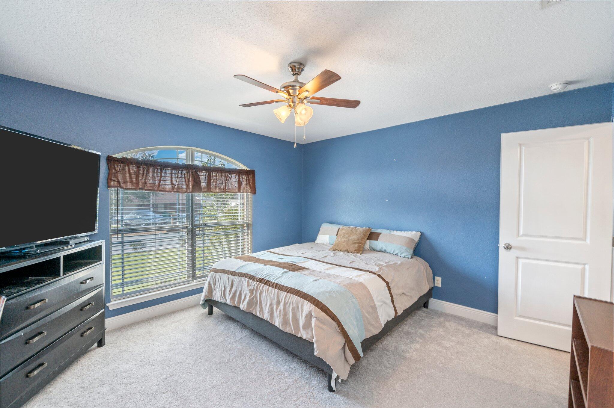 6262 Evan Circle Crestview, FL 32536 - Photo 29 of 45 a bedroom with a bed and a flat tv screen on dresser
