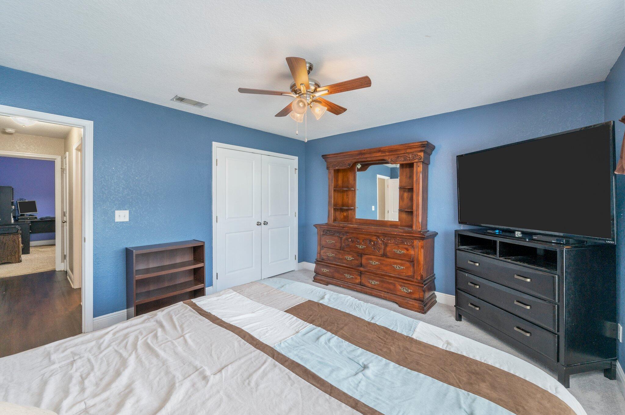 6262 Evan Circle Crestview, FL 32536 - Photo 30 of 45 a bedroom with a bed and flat screen tv