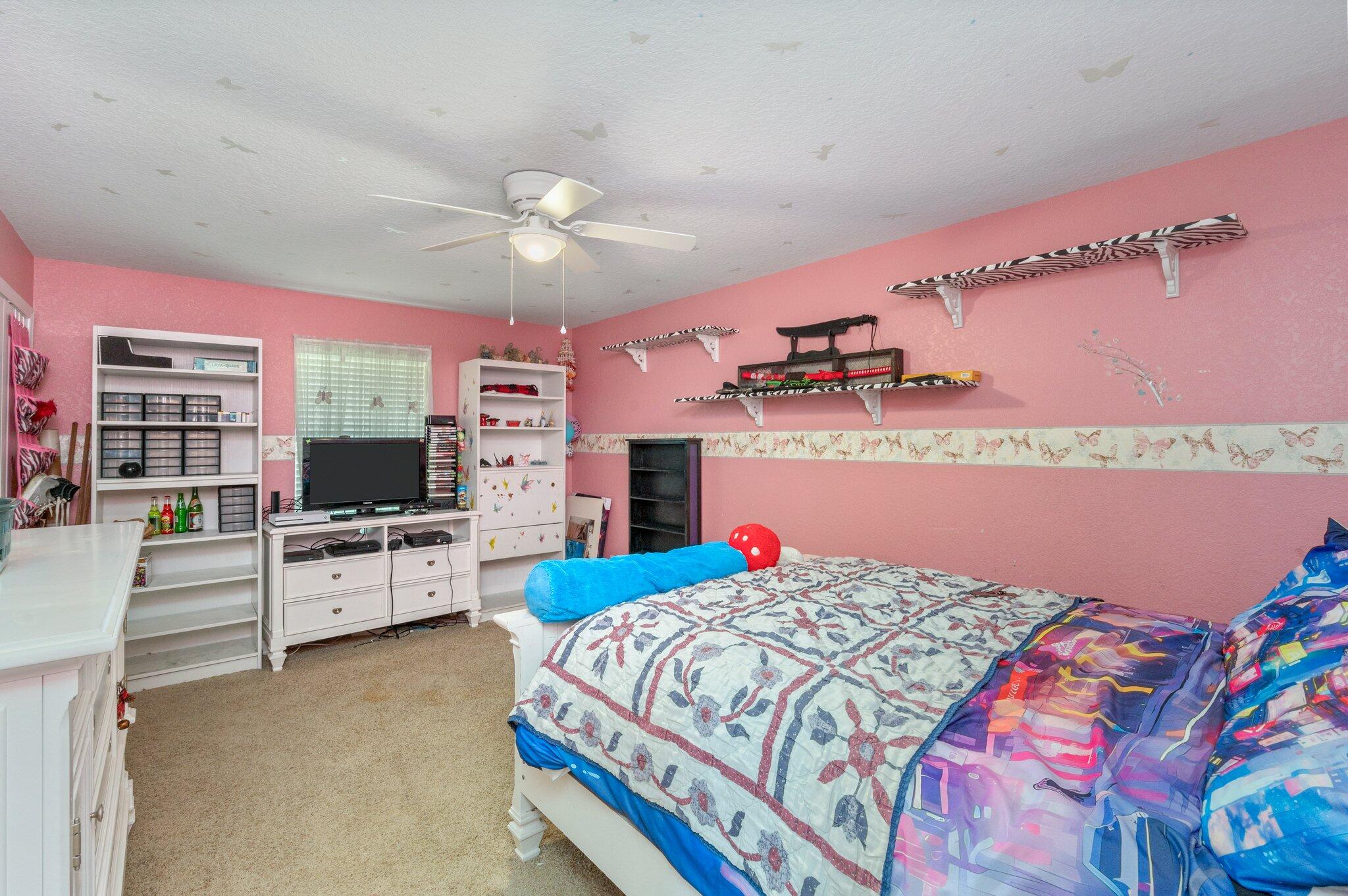 6262 Evan Circle Crestview, FL 32536 - Photo 33 of 45 a bedroom with a bed dresser and flat screen tv