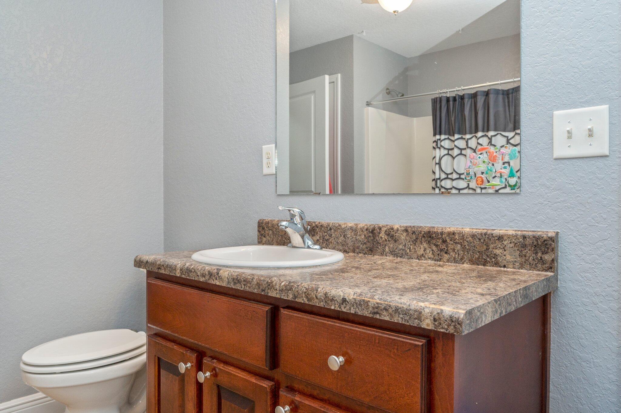 6262 Evan Circle Crestview, FL 32536 - Photo 35 of 45 a bathroom with a granite countertop sink and a toilet