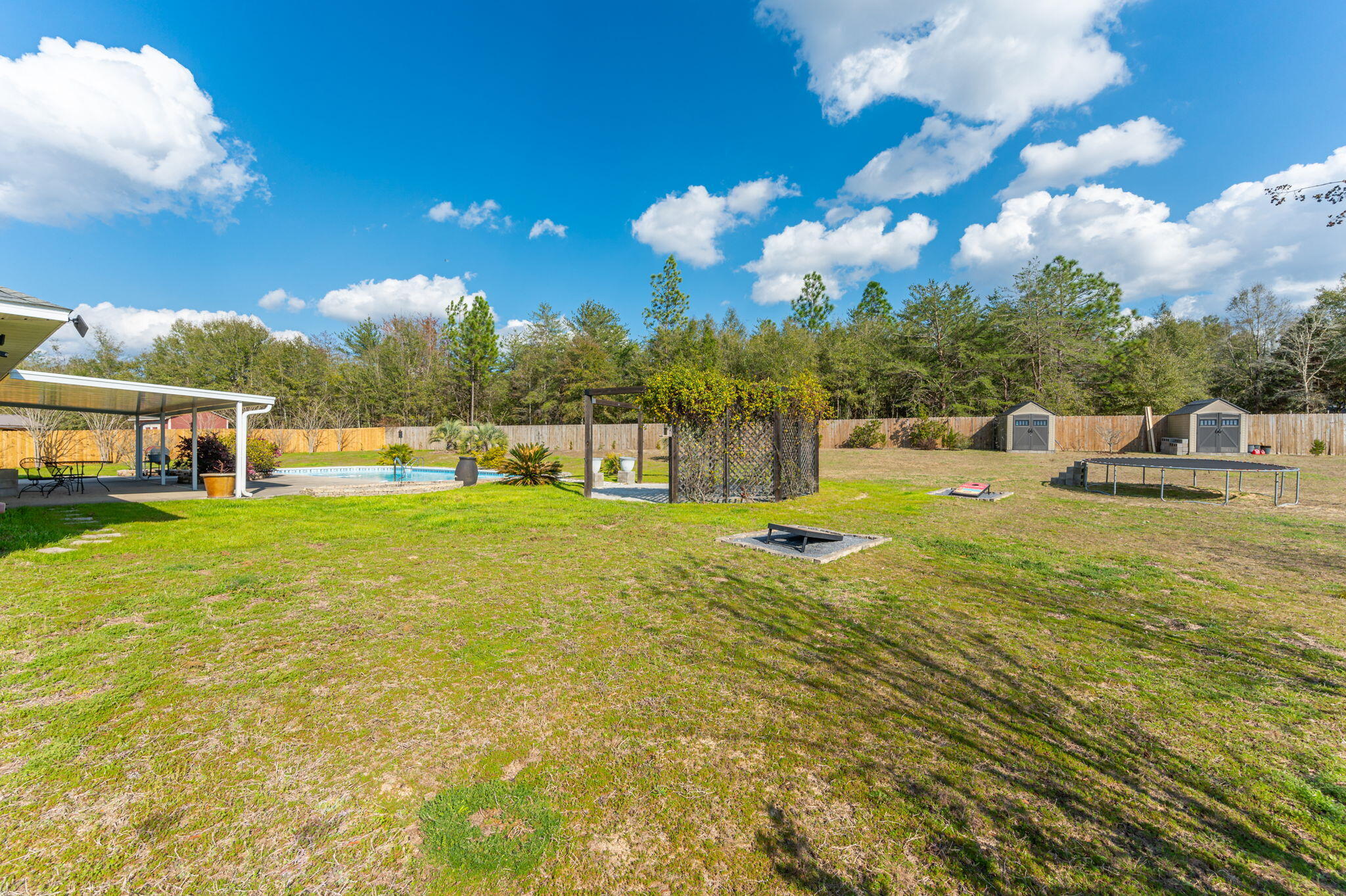 6262 Evan Circle Crestview, FL 32536 - Photo 4 of 45 a view of a swimming pool with an outdoor seating