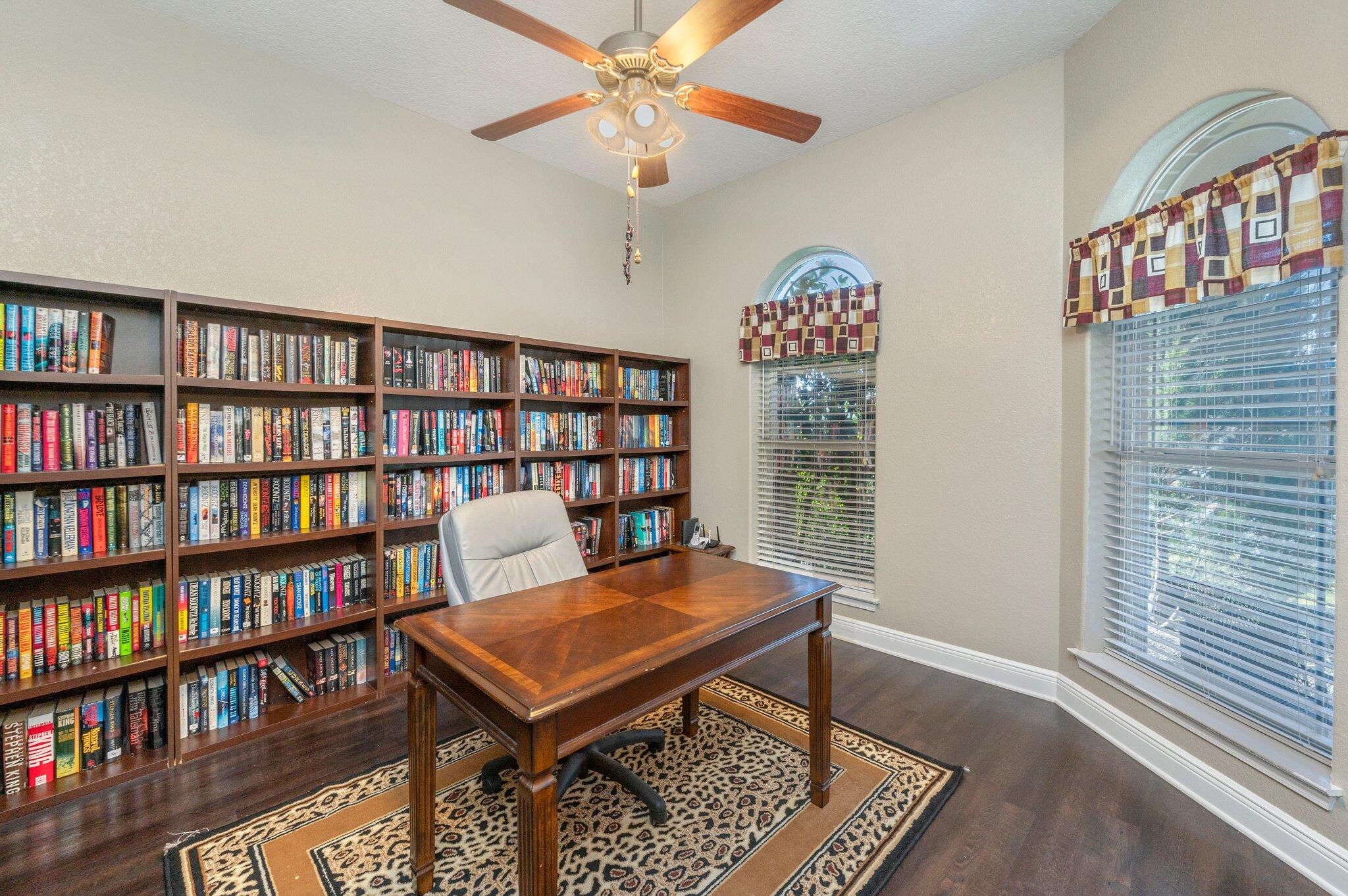 6262 Evan Circle Crestview, FL 32536 - Photo 9 of 45 a view of a workspace with furniture bookshelf and a window