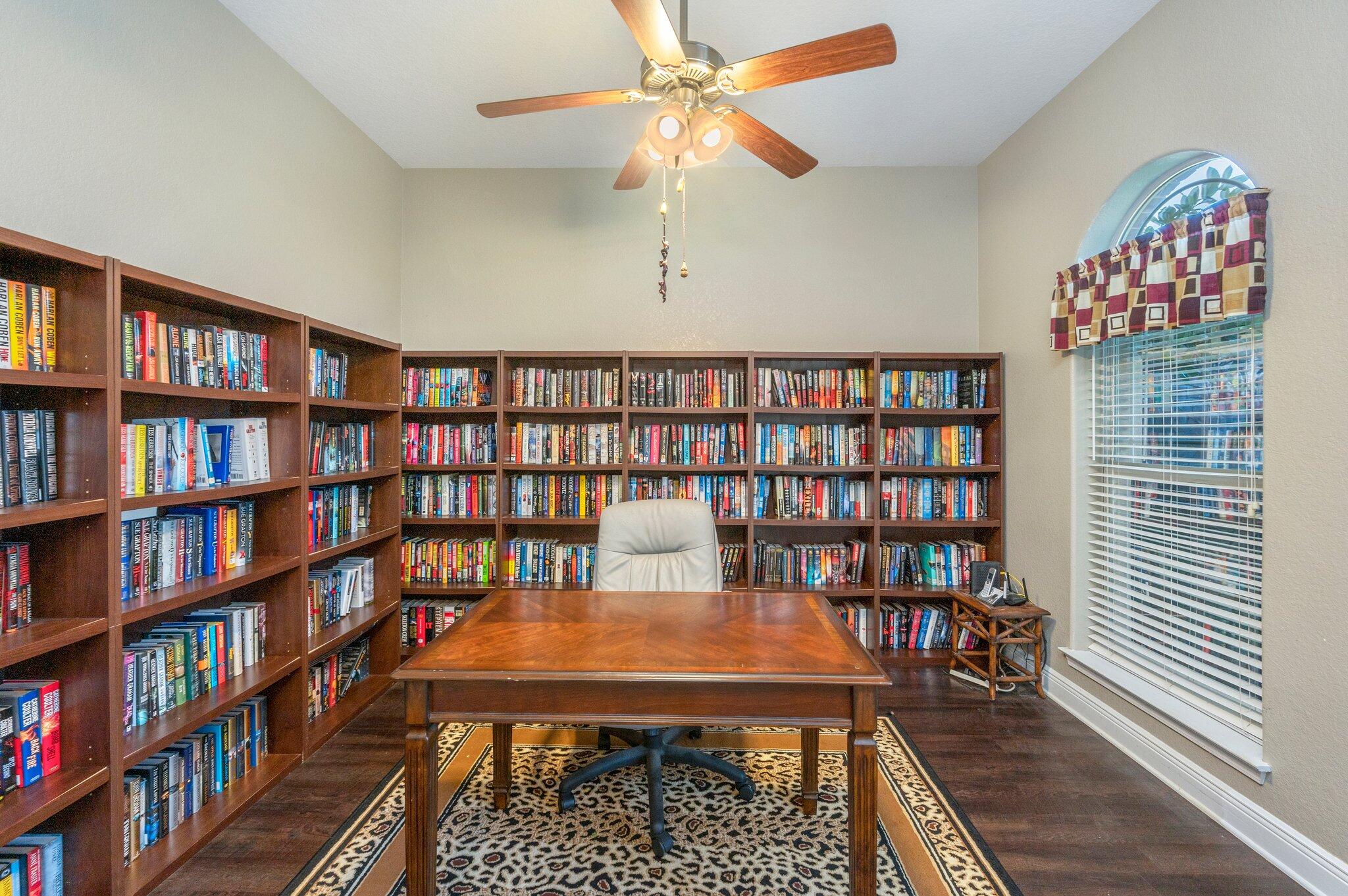 6262 Evan Circle Crestview, FL 32536 - Photo 10 of 45 a reading room with furniture book shelf and a chandelier