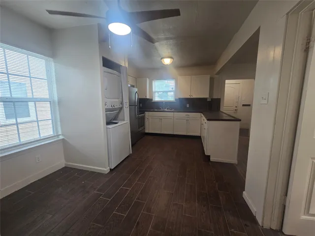 a kitchen with a refrigerator and a stove top oven