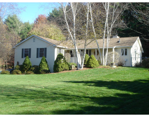 294 Brookfield Road Sturbridge, MA 01518 - Photo 9 of 28 a front view of a house with a garden