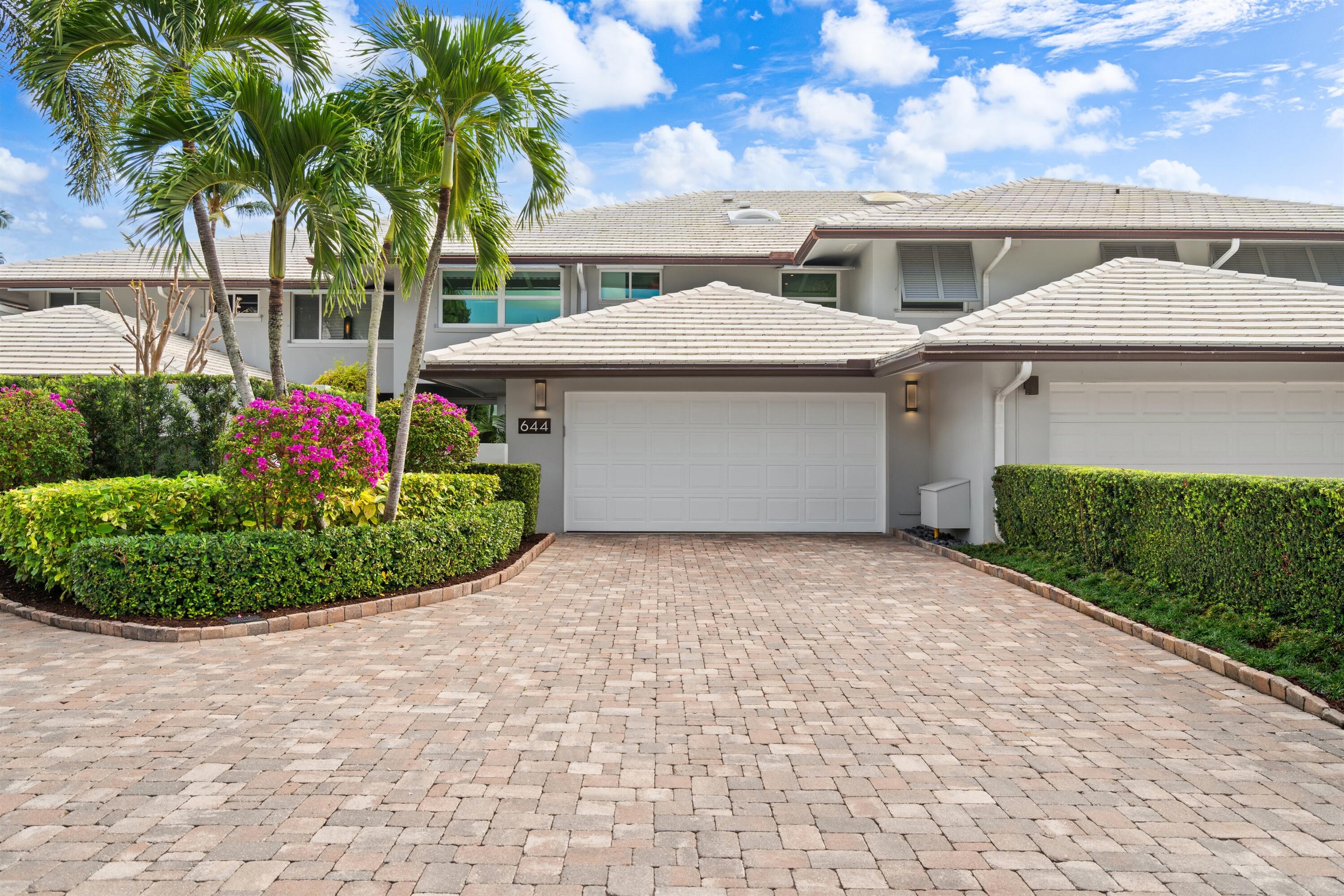 644 Boca Marina Court Boca Raton, FL 33487 - Photo 1 of 1 a view of a white house with a yard and potted plants