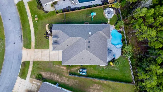 an aerial view of a house with a yard