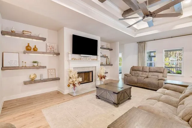 a living room with furniture fireplace and a flat screen tv
