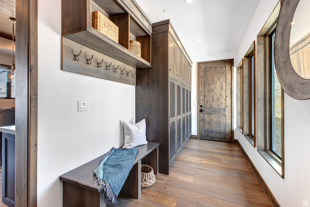 1282 Chimney Rock Road, Unit 344 Heber City, UT 84032 - Photo 24 of 55 Entryway featuring wood-finish flooring, built-in bench with storage, integrated wall hooks, and a custom wood door