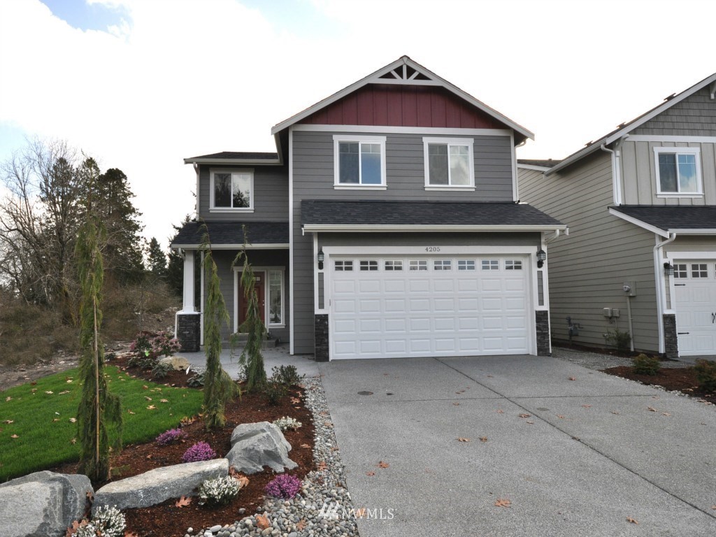 3290 Prill Road Centralia, WA 98531 - Photo 1 of 3 a front view of a house with a yard and garage